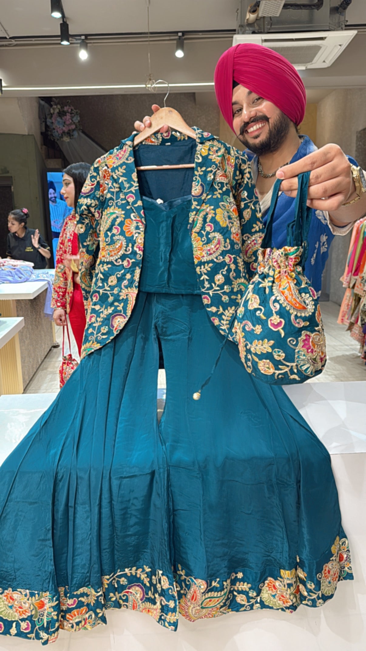 Peacock Crepe Designer Flairy Bell Bottom Crop Set with Heavy Hand embroidered Blazer & Potli
