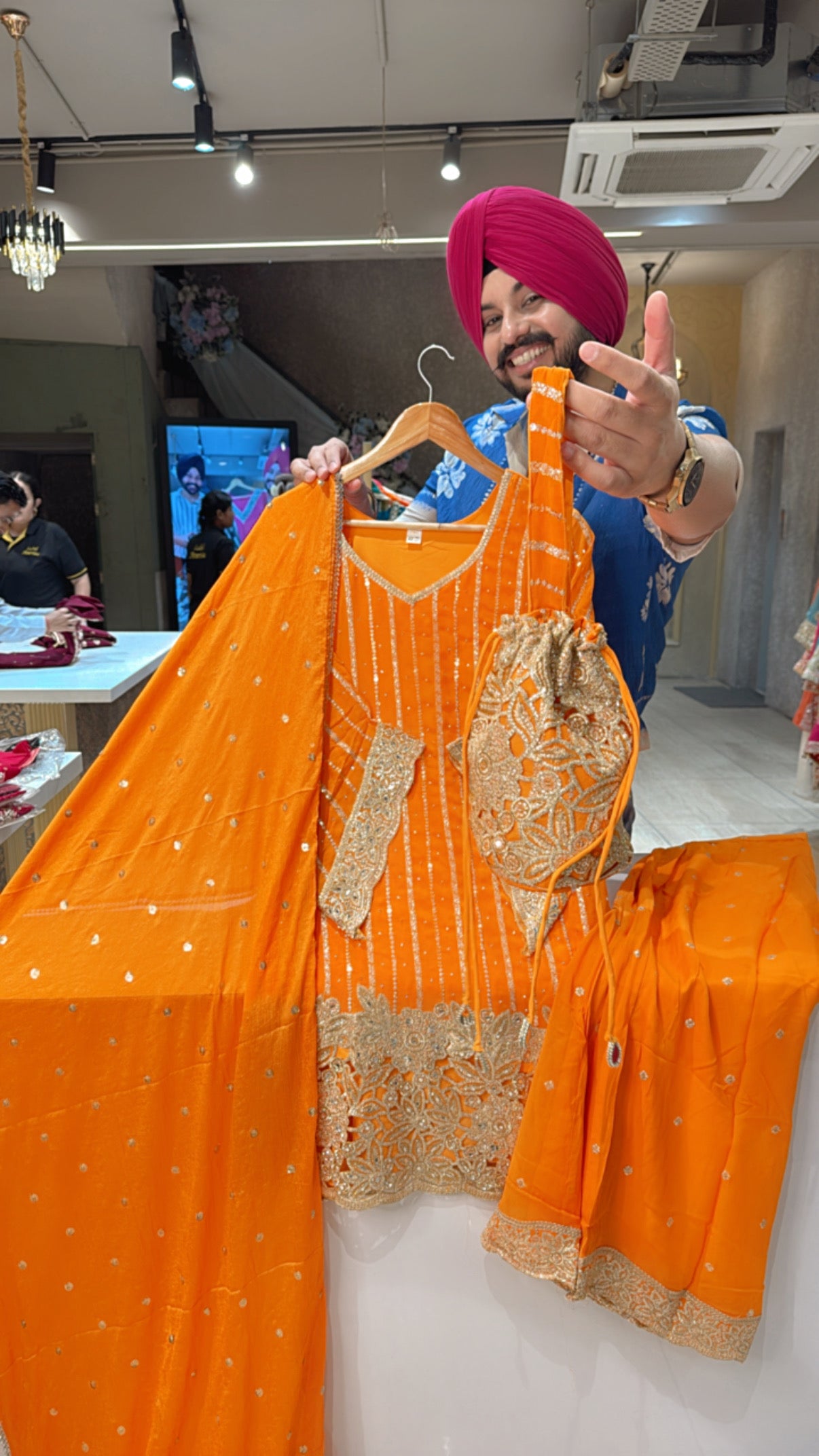 Orange Georgette Heavy Sequins & Cutwork Bell Bottom Party Wear suit with Designer Sleeves & Potli