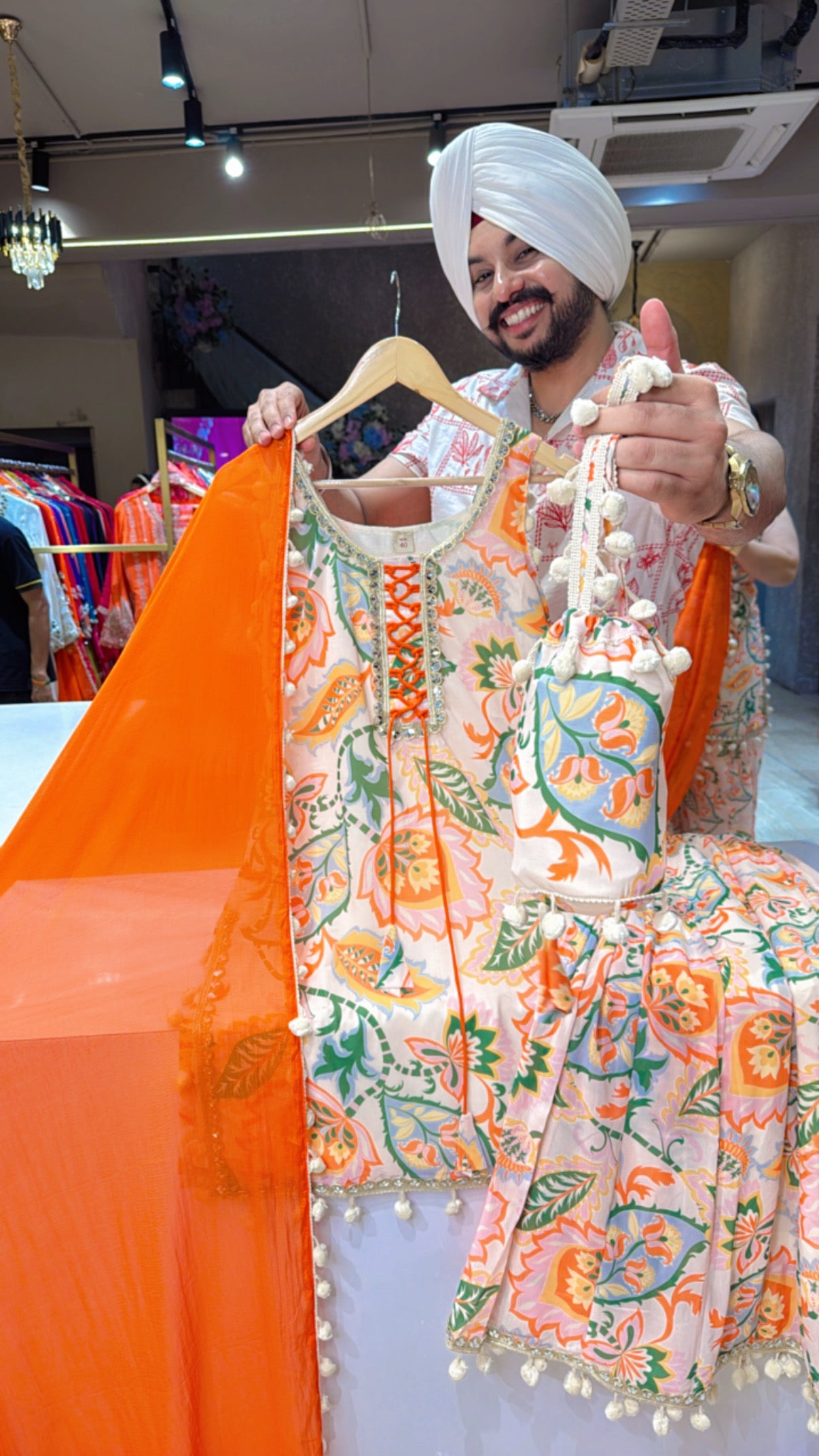 Light Beige & Orange Chiffon Full Flair Pom-Pom Sharara Suit with Pom-Pom Dupppata & Cute Potli