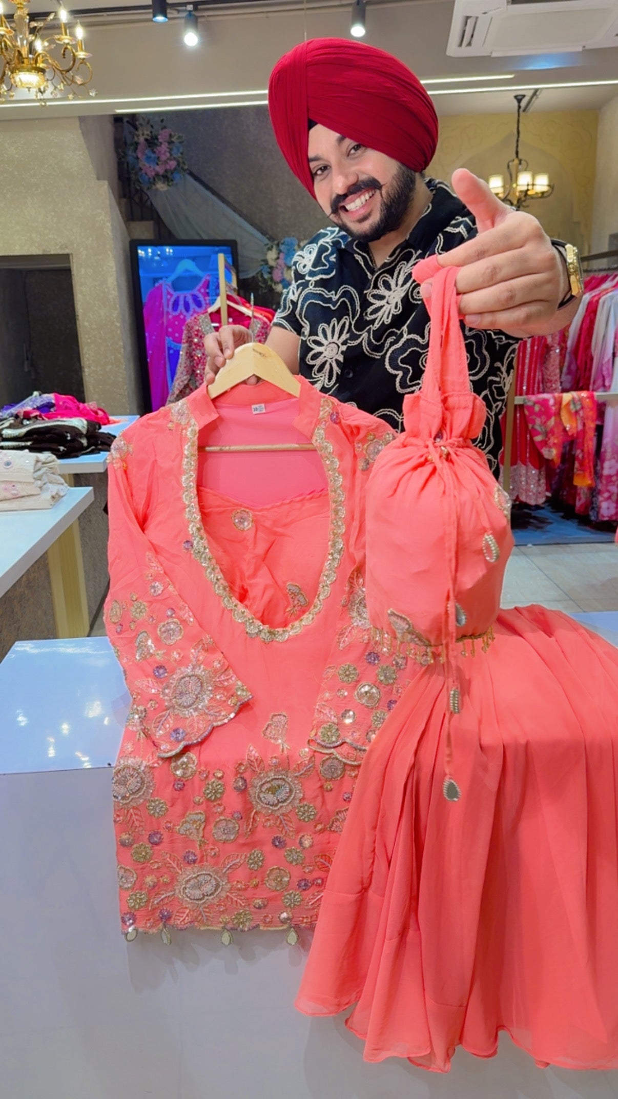 Peachish Pink Georgette Heavy Embroidered Bell Bottom Set with Embroidered Bustier & Potli