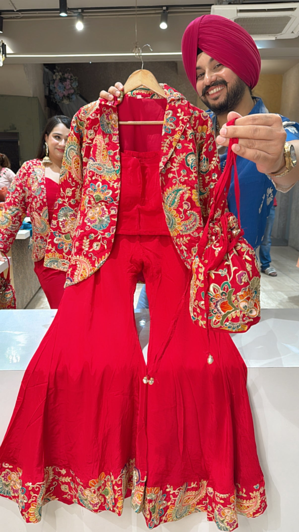 Red Crepe Designer Flairy Bell Bottom Crop Set with Heavy Hand embroidered Blazer & Potli
